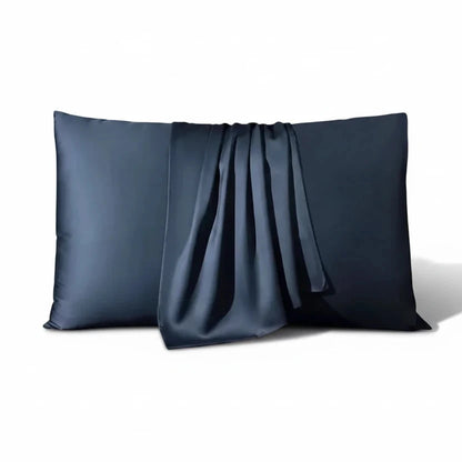 Two navy blue satin pillows on a white background